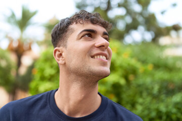 Canvas Print - Young hispanic man smiling confident looking to the side at park