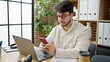 © Krakenimages.com - Young hispanic man business worker using laptop and smartphone at office