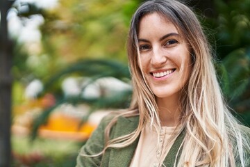 Wall Mural - Young woman smiline confident standing at park