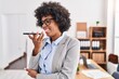 © Krakenimages.com - African american woman business worker talking on smartphone working at office