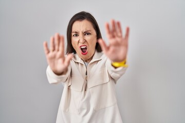 Sticker - Middle age hispanic woman standing over isolated background doing stop gesture with hands palms, angry and frustration expression