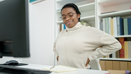 Canvas Print - African american woman student using computer suffering for backache at library university