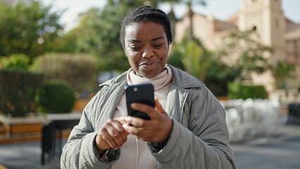 Poster - African american woman using smartphone smiling at park