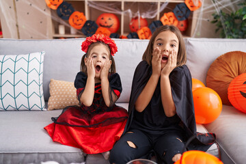 Canvas Print - Adorable boy and girl wearing halloween costume with surprise expression at home