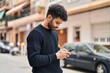 © Krakenimages.com - Young arab man using smartphone at street