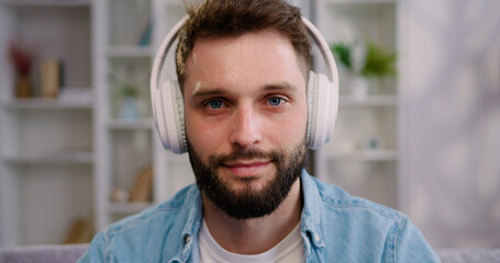 Portrait of man manager in headphones looking at camera. Videocall application solve business remotely conference app job interview participant concept.