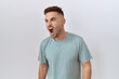 © Krakenimages.com - Hispanic man with beard standing over white background angry and mad screaming frustrated and furious, shouting with anger. rage and aggressive concept.