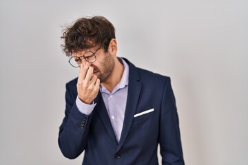 Poster - Hispanic business man wearing glasses tired rubbing nose and eyes feeling fatigue and headache. stress and frustration concept.