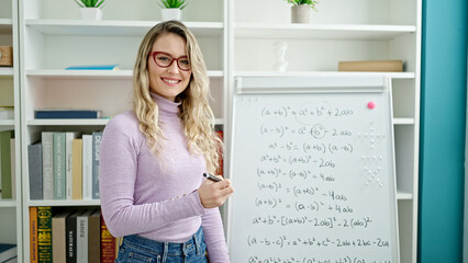 Canvas Print - Young blonde woman teacher teaching maths lesson at classroom