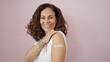 © Krakenimages.com - Middle age hispanic woman smiling confident standing with band aid on arm over isolated pink background