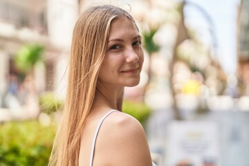 Canvas Print - Young caucasian woman smiling confident standing at street