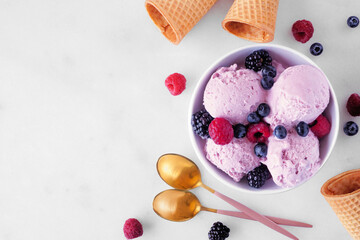 Poster - Bowl of field berry ice cream. Top view table scene with copy space over a white marble background.