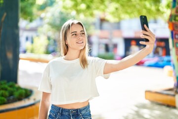 Poster - Young blonde woman smiling confident making selfie by the smartphone at park