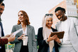© Vane Nunes - Business multiracial group of people having outdoor meeting outside office - Focus on left woman face