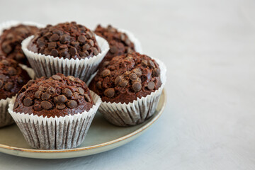 Wall Mural - Homemade Dark Chocolate Muffins on a Plate, low angle view.