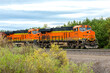 Dual engine freight train pulling cargo on a warm spring day close to Whitefish, Montana