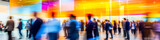 Fototapeta  - blurred business people walking at a trade fair, conference or walking in a modern hall
