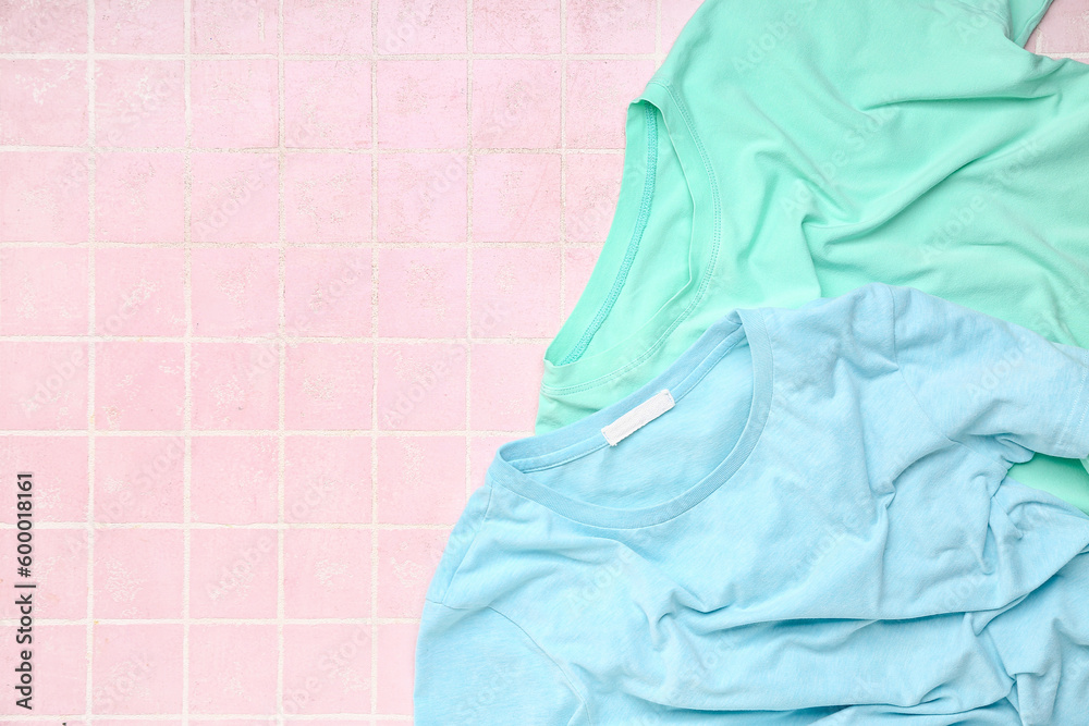 Blue t-shirts on pink tile background