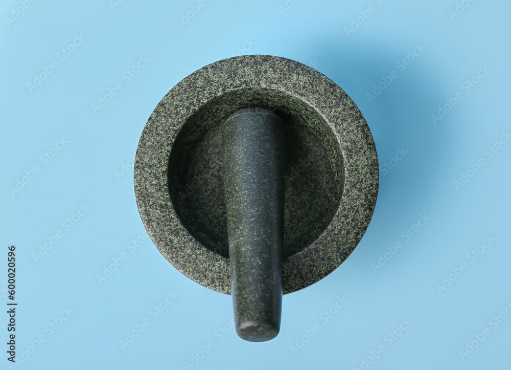 Mortar and pestle on blue background Stock Photo | Adobe Stock