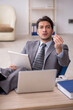 © Elnur - Young male employee working in the office