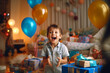 © wetzkaz - little kid laughing and looking forward smiling, hands and arms up with joy, birthday and birthday gifts. Generative AI