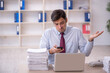 © Elnur - Young male employee and too much work in the office