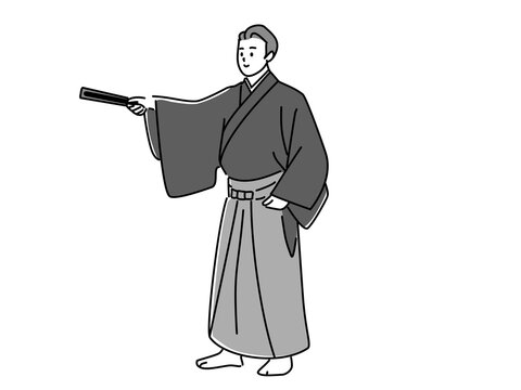 扇子で指し示す袴姿の男性