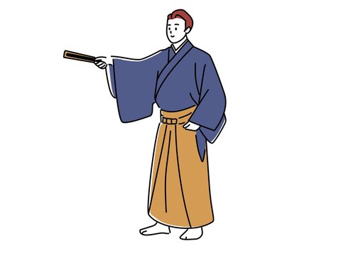 扇子で指し示す袴姿の男性