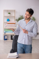 Wall Mural - Young male student employee in the office