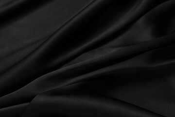 Part of the dark fabric texture of the fabric for the background and decoration of the work of art, a beautiful crumpled pattern of silk or linen. A crumpled piece of cloth