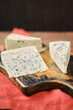 Closeup photo with shallow depth of field of different types of blue cheese with mold