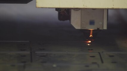 Poster - Machine cnc in factory cuts part out of metal, closeup. Factory mechanism works by cutting out detail from an iron sheet, closeup. Machine automatically cuts steel
