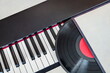 vinyl record lies on the piano keys
