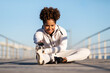© Prostock-studio - Outdoor Activities. Smiling Sporty Black Woman Warming Up Before Training