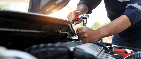 Automobile mechanic repairman hands repairing a car engine automotive workshop with a wrench, car service and maintenance,Repair service.