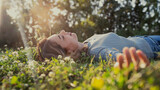 Fototapeta Łazienka - Relaxed woman resting on the grass
