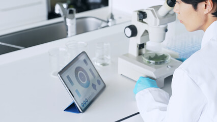 Poster - A man observing with a microscope. Scientific experiment.