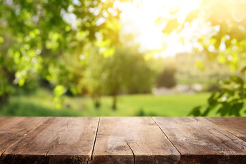Empty rustic table in front of countryside background. product display and picnic concept