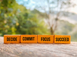 Inspirational and motivational quote - decide commit focus succeed on bricks background.