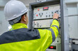 © reewungjunerr - Electrical engineer woman checking voltage at the Power Distribution Cabinet in the control room,preventive maintenance Yearly,Thailand Electrician working at company