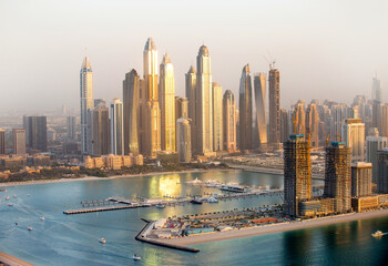 Sticker -  Dubai Marina skyscrapers view at golden sunset with beautiful reflection in water. Dubai, UAE.