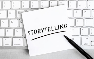 Leinwandbilder - White paper with text STORYTELLING lying on the keyboard