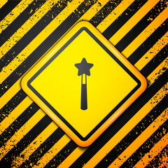 Sticker - Black Magic wand icon isolated on yellow background. Star shape magic accessory. Magical power. Happy Halloween party. Warning sign. Vector