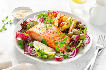 Wall Mural - Salmon fillet grilled, fried potato and fresh vegetable green salad