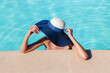 Fashion portrait of woman in bikini relaxing in swimming pool spa