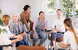 © JackF - Cheerful carefree female colleagues of various ages friendly talking sitting in circle on chairs in office lounge during break, sharing personal stories
