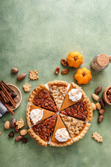 Wall Mural - Traditional Thanksgiving pies cut into slices with pumpkin, pecan and crumble