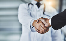 Closeup, Doctor And Man With Handshake, Consultation And Partnership For Healthcare Development, Growth And Agreement. Zoom, Medical Professional And Patient With Greeting, Shaking Hands And Wellness