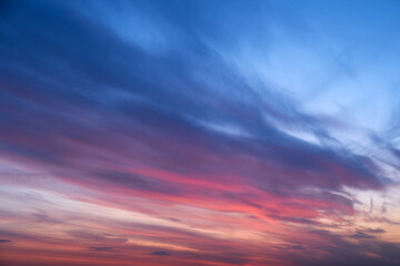 Wall Mural - Evening clouds in the sunset sky in the light of the rays of the setting sun