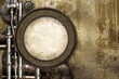 Vintage steampunk backdrop with round frame, pipes on stucco wall. Open space with concrete wall and pipelines. Copy space for text. Grunge interior retro background